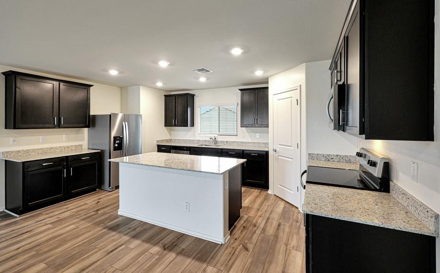 This kitchen has a beautiful granite island.