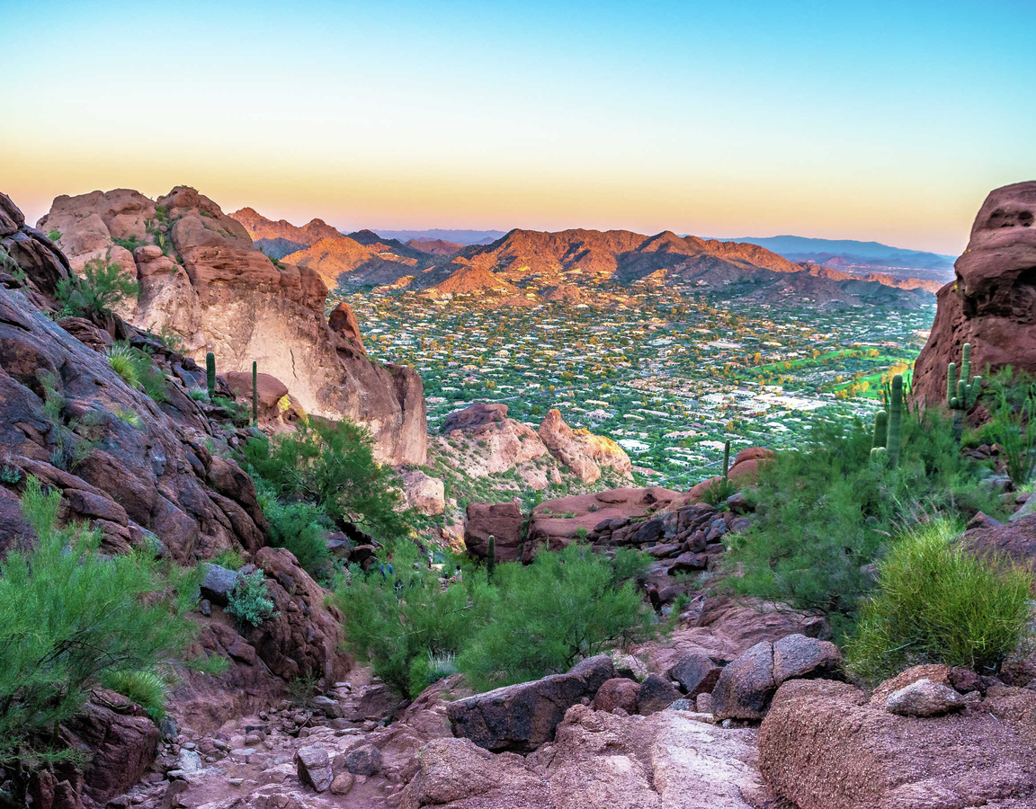 Phoenix, Arizona Camelback Mountain from the top looking down on numerous desert plants, cacti, and multi-colored rocks