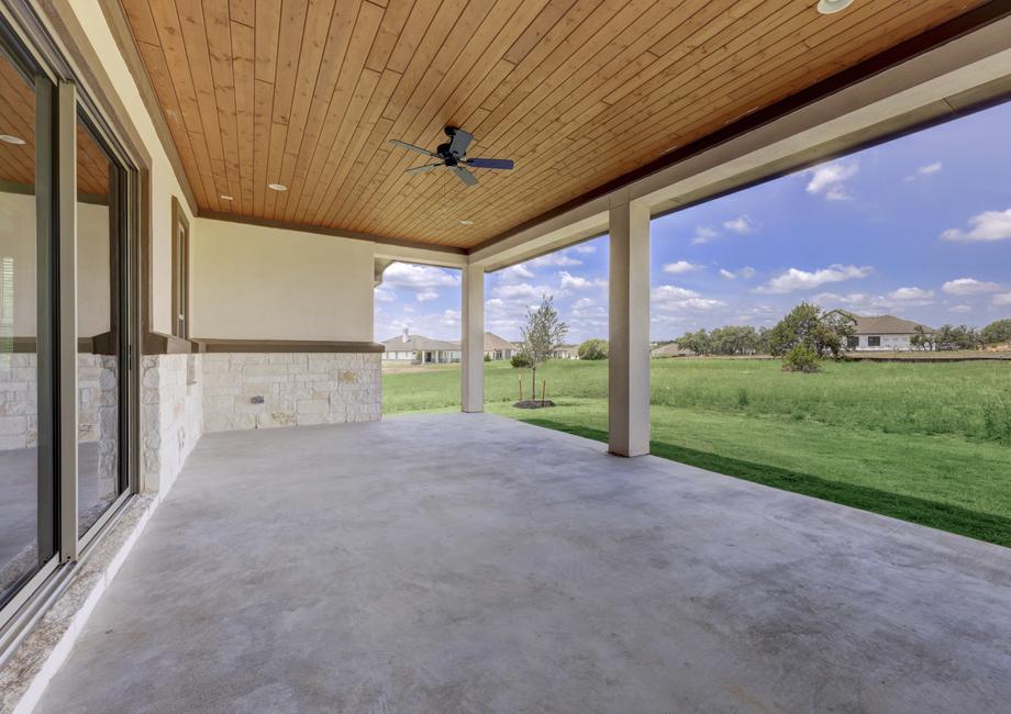 Expansive covered back patio with a ceiling fan, overlooking the stunning scenery that Esperanza has to offer.