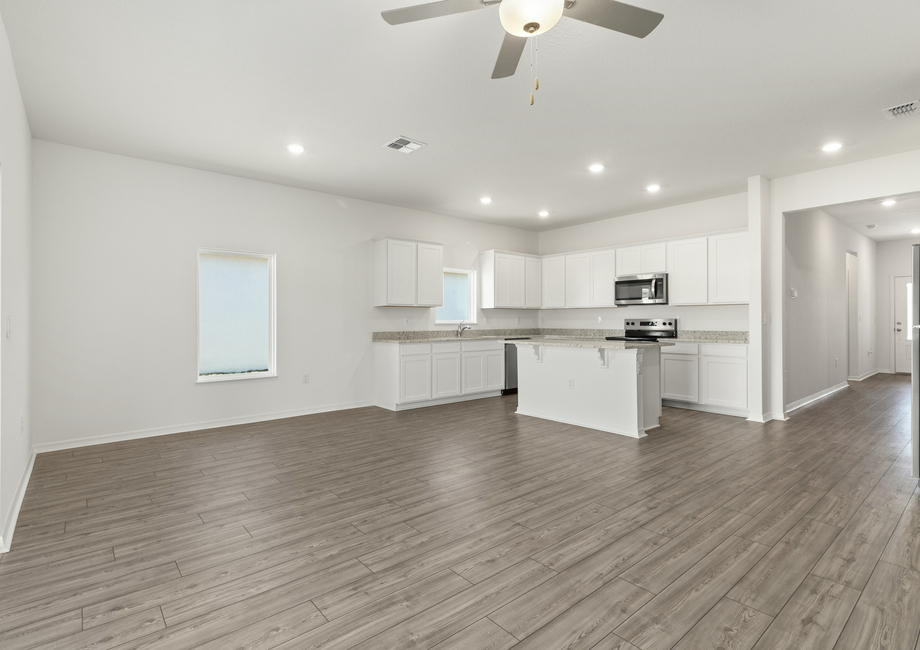 Luxury vinyl flooring fills the main living areas