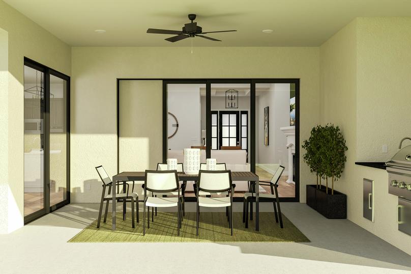 Rendering showing the Fairview floor
  plan's covered patio with built-in grill and wet bar. A table, chairs,  outdoor rug and potted plants decorate the inviting space.