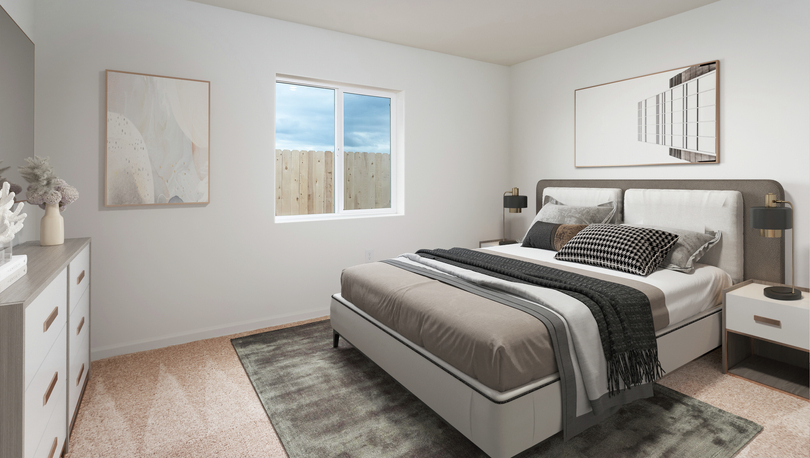 The master bedroom is spacious with room for a king bed and two side tables.