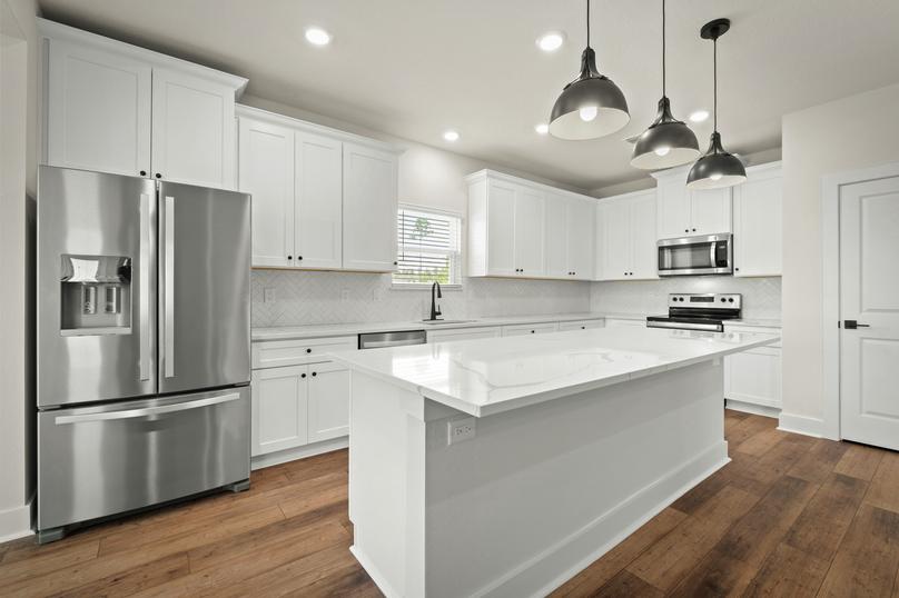 Stainless steel kitchen appliances are included.