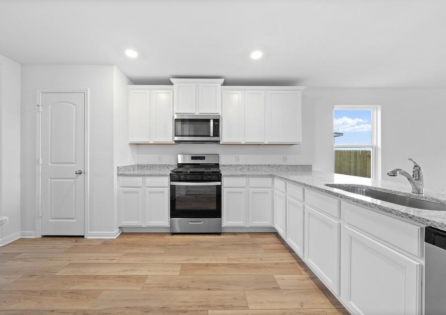 The kitchen has stainless steel appliances and granite countertops.