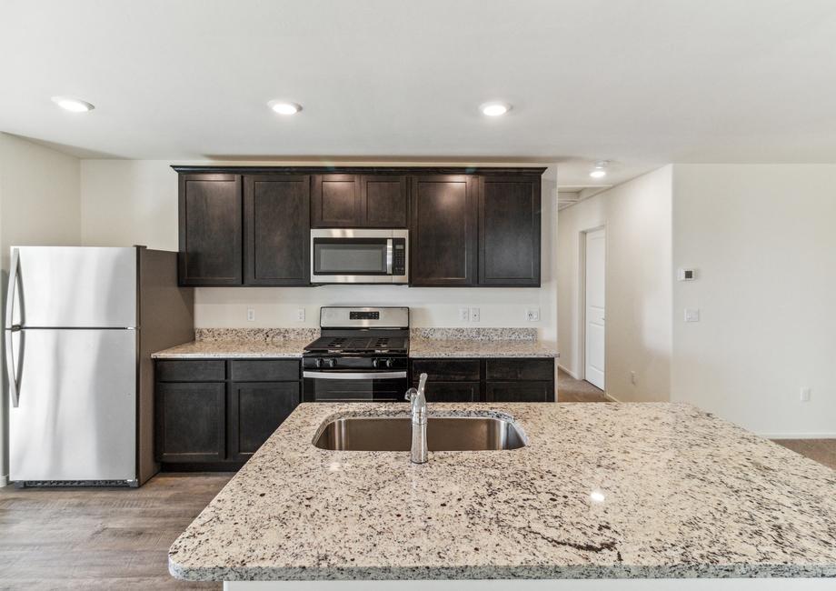 The kitchen features a large island and stainless steel appliances.
