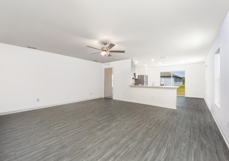 A large family room with an adjoining kitchen