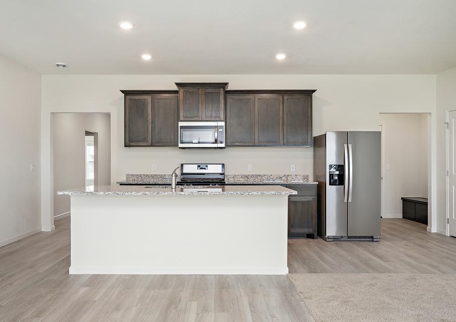 The kitchen has a large island that overlooks the entertainment space