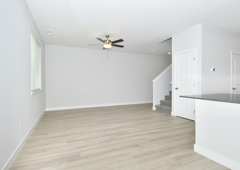 The family room is spacious with a ceiling fan.