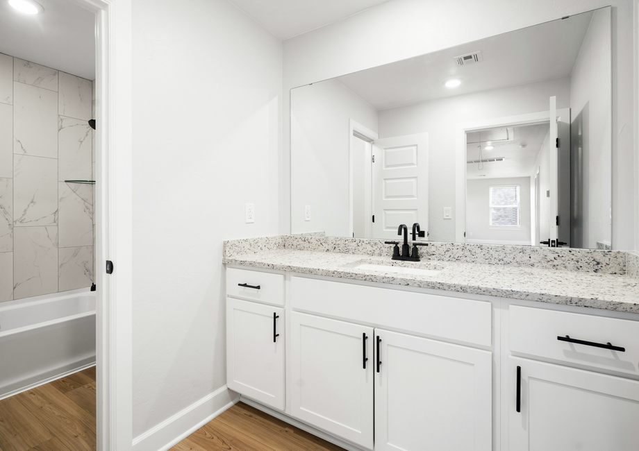 The secondary bathroom has a large vanity with plenty of counterspace.