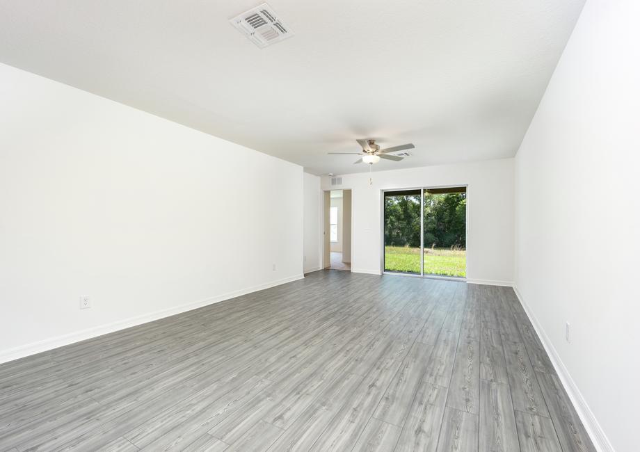 A spacious family room with sliding doors to the back patio