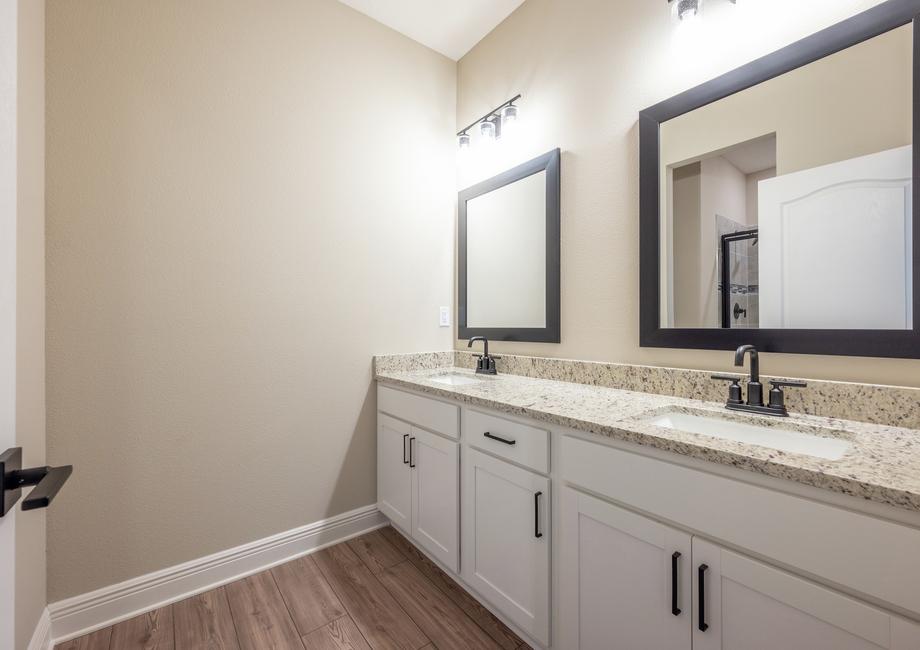 The master bathroom includes two sinks and plenty of storage.