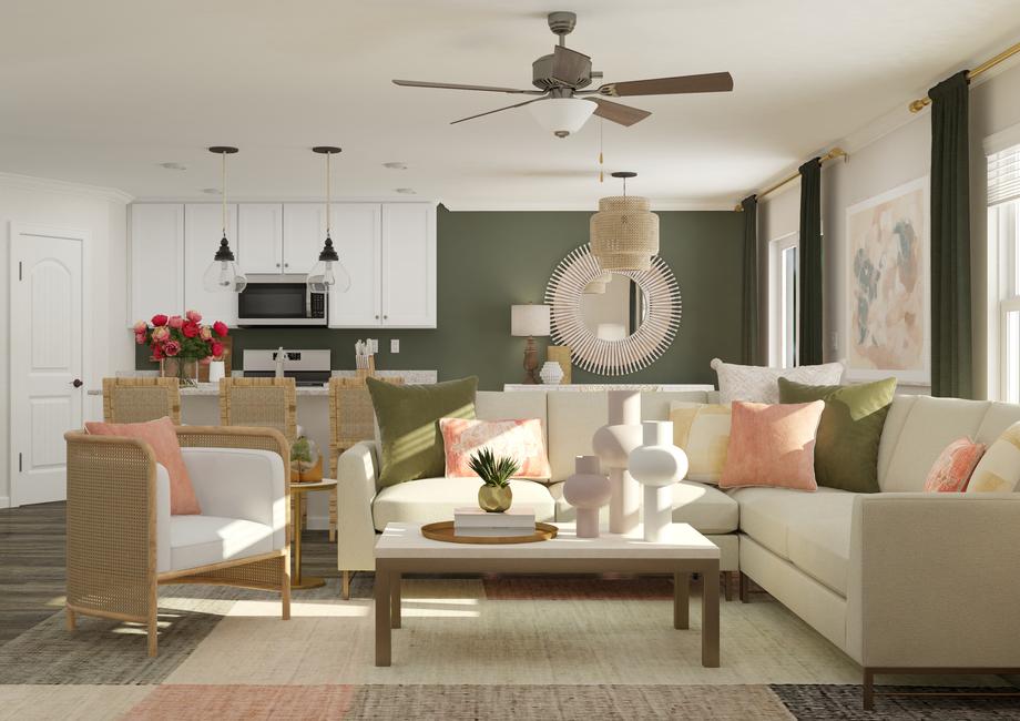 Rendering of the living room showcasing
  the open floor plan of this new construction home. In the foreground is a
  sectional, accent chair and coffee table. In the background the kitchen and
  breakfast area are visible.