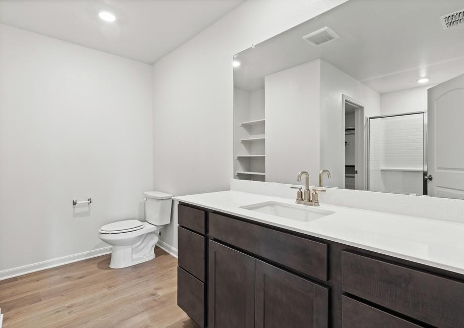 The master bathroom has a large vanity space.