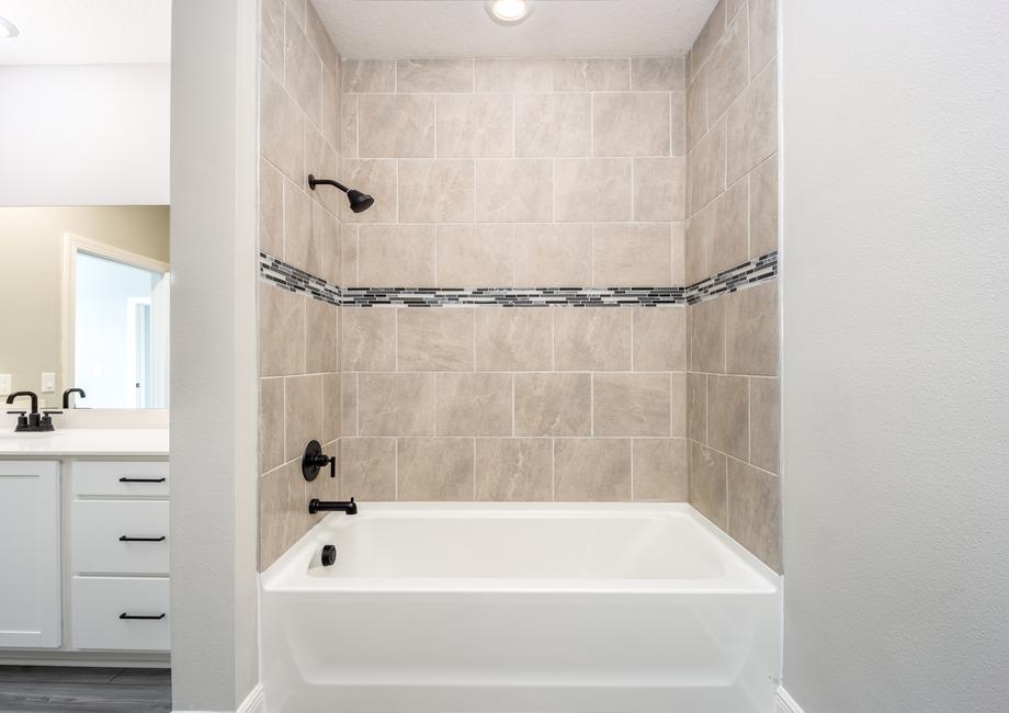 Beautiful tile details surround the the shower/tub combination