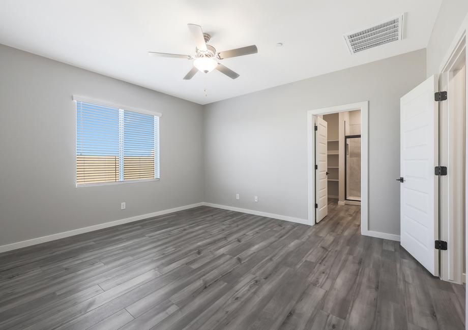 Spacious master bedroom with an attached bathroom and walk-in closet.