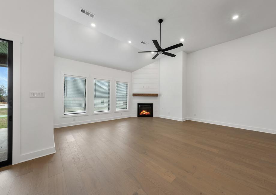 The spacious family room has large windows and an electric fireplace.