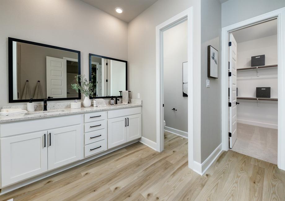 The large vanity in the master bath has granite countertops and black hardware.