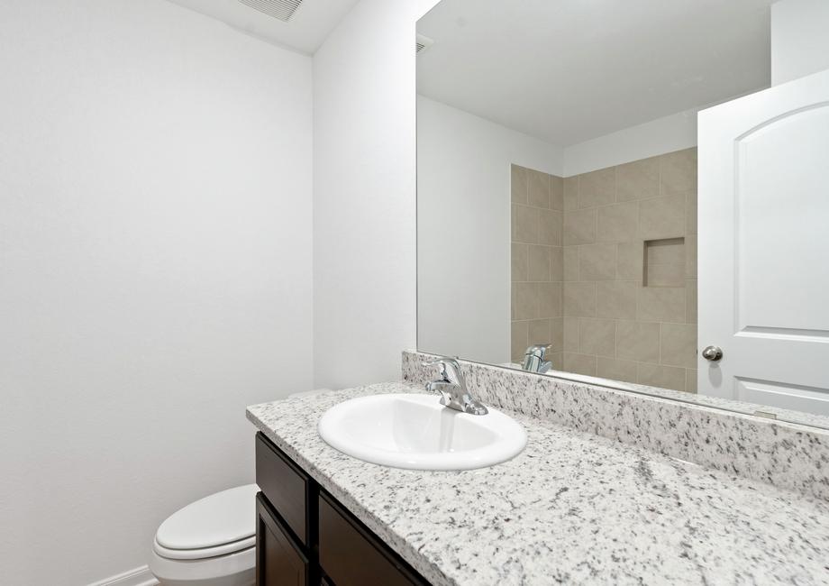 Secondary bathroom with a dual shower and tub.