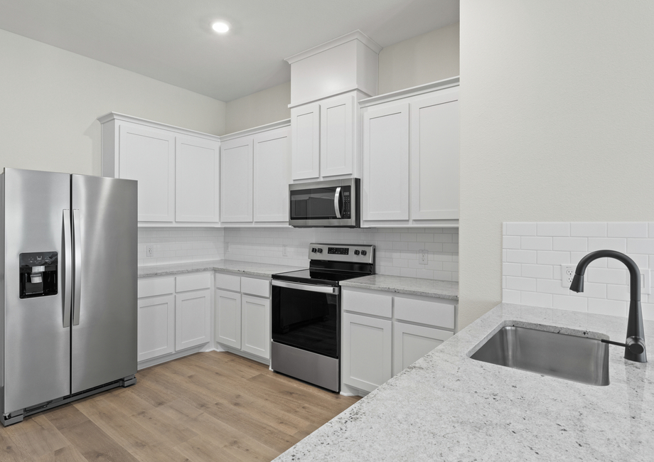 The kitchen of the Noma has beautiful white wood cabinetry.