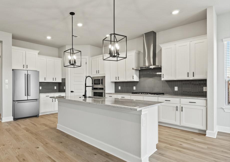 Enjoy an oversized island with black pendant lights.