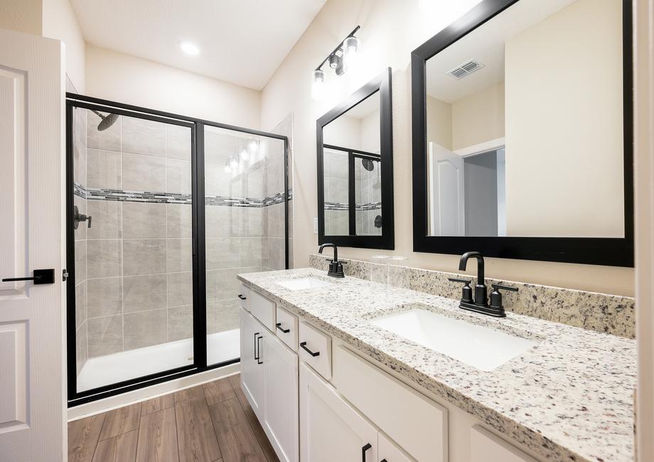 The master bathroom has a walk-in shower and two sinks.