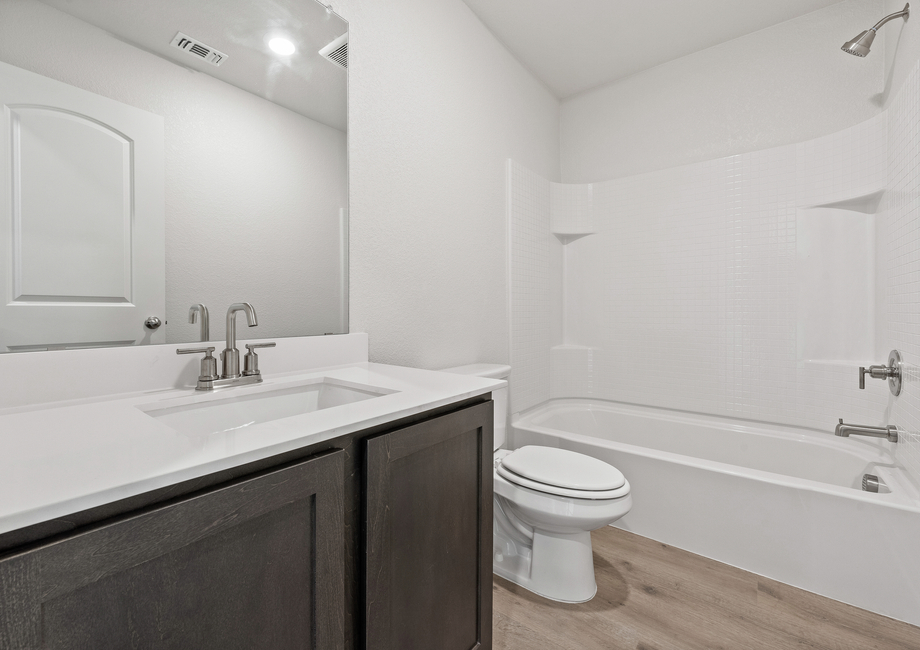 The secondary bathroom of the Rio Grande has a large vanity space and a shower-tub combo.