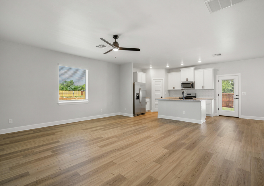 The open concept floor plan connects the kitchen, dining room and family room creating open living spaces.