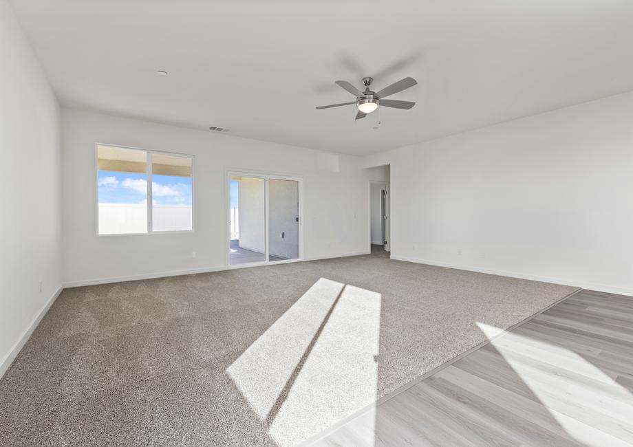 The family room is off of the kitchen and has a ceiling fan.