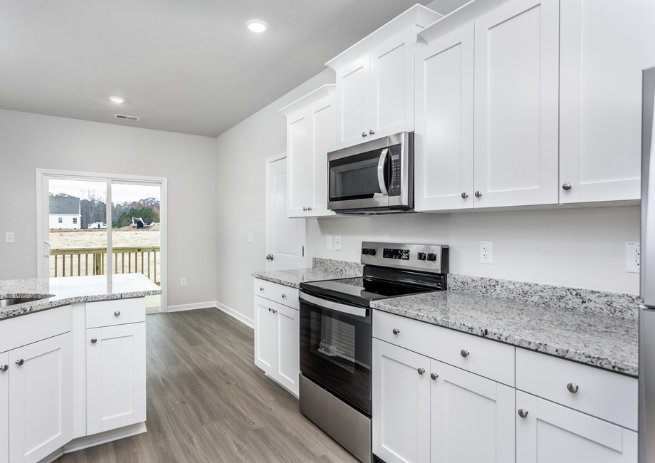 The kitchen has beautiful wood cabinetry