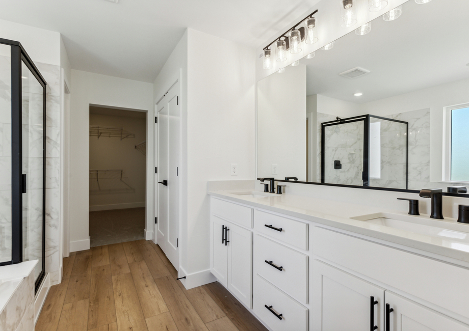 The master bathroom has a large vanity with plenty of counterspace.