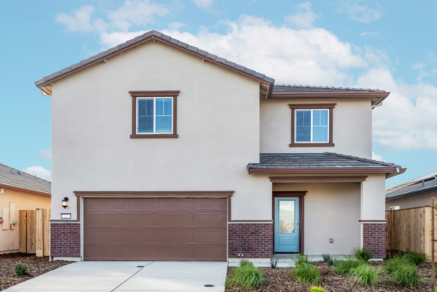 The Palomino is a beautiful home with stucco and brick.