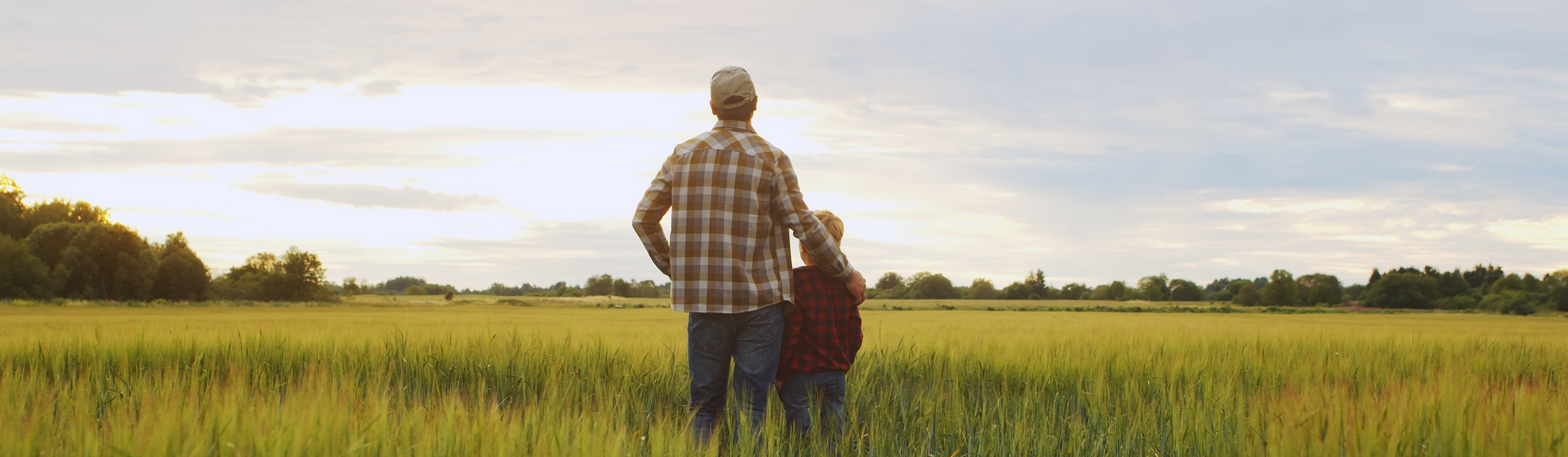 Family standing in plain field