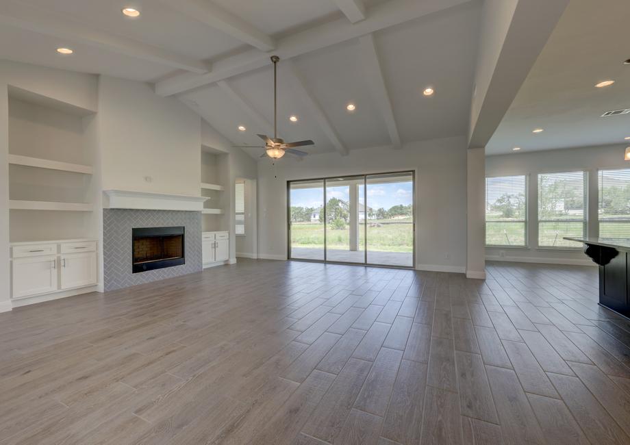 Spacious layout with the kitchen overlooking the expansive living room, featuring a fireplace.