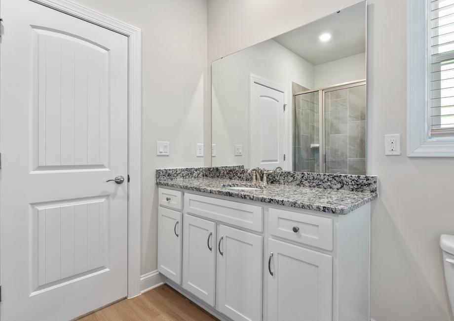 Large bathroom vanity and walk-in shower.