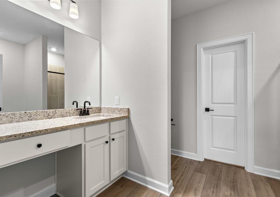 The master bath has a private commode and tons of drawer space.
