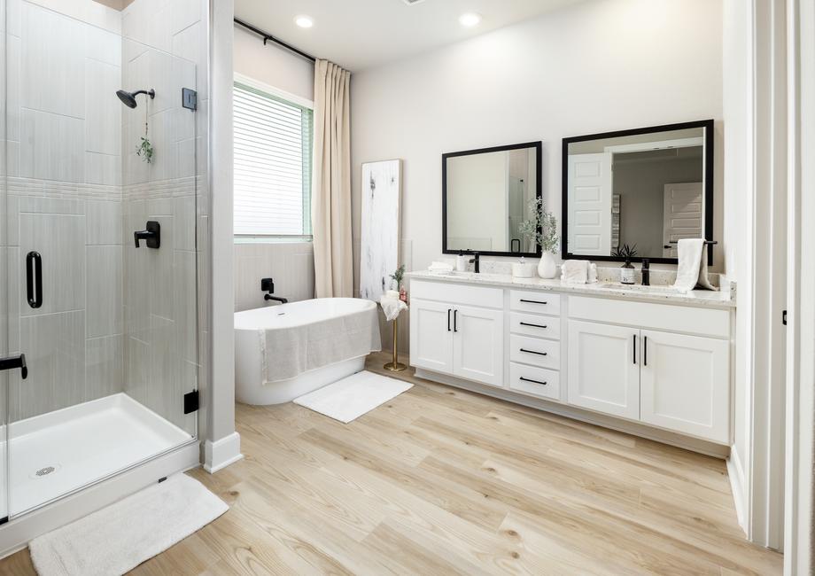 In the master bath you will find a relaxing standalone tub, a walk-in shower and a framed vanity mirror.