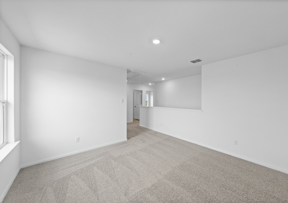 A upstairs game room with large carpet