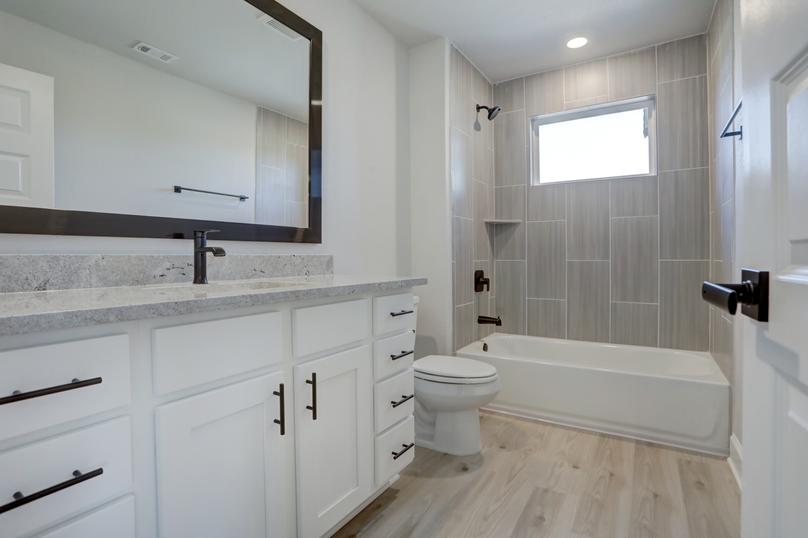 Guest bathroom with a large vanity and dual shower and tub.