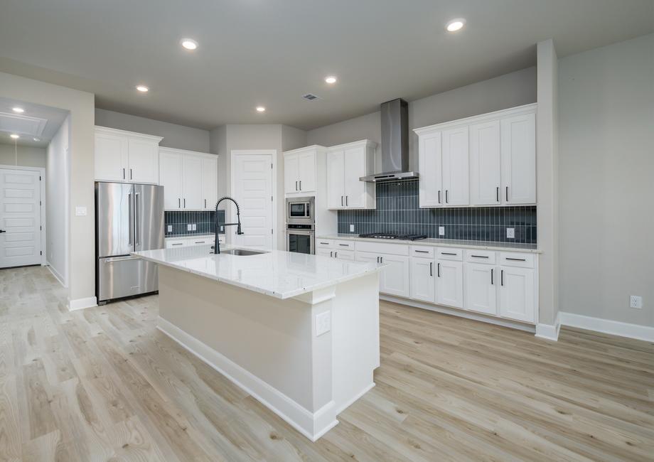 The kitchen includes stainless steel KitchenAid appliances.