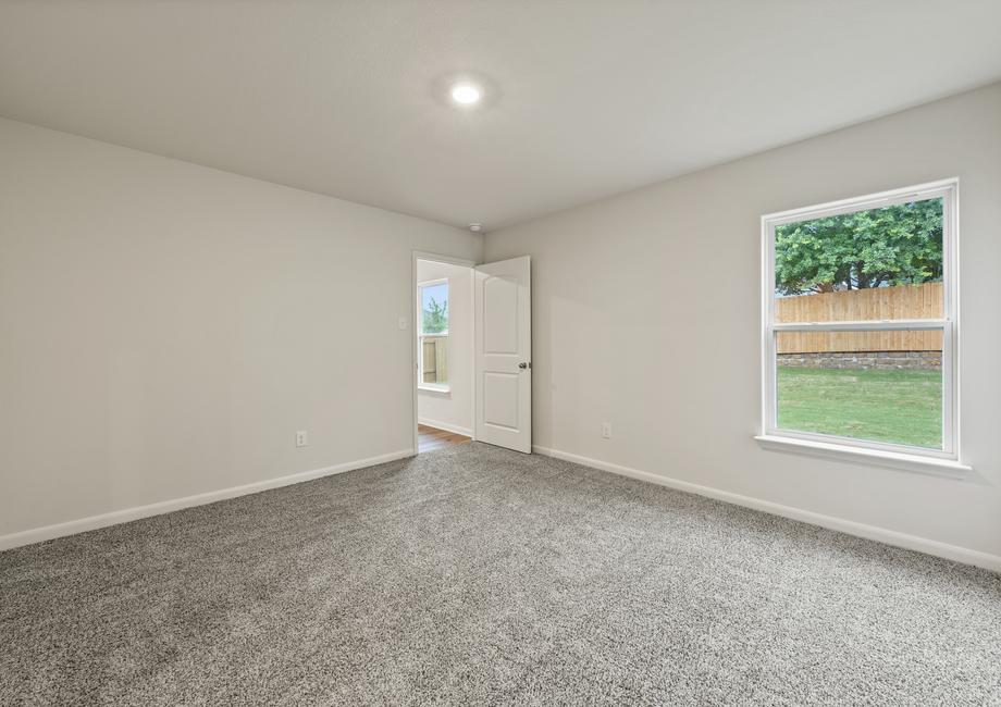 The master bedroom in the Rio Grande is large enough for your king sized furniture, and includes a large window with a great view of the back yard.