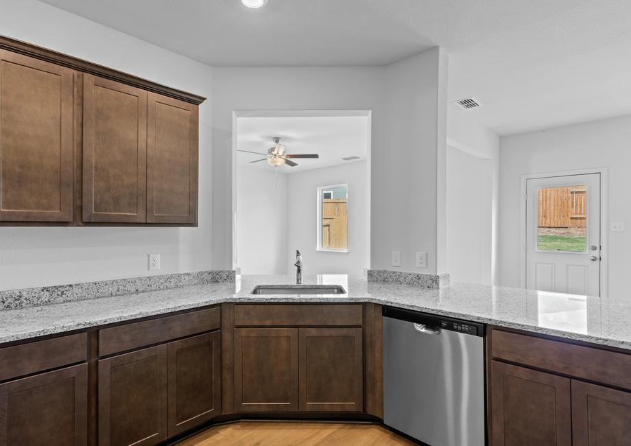 The kitchen has a window over the sink that looks out into the family room.