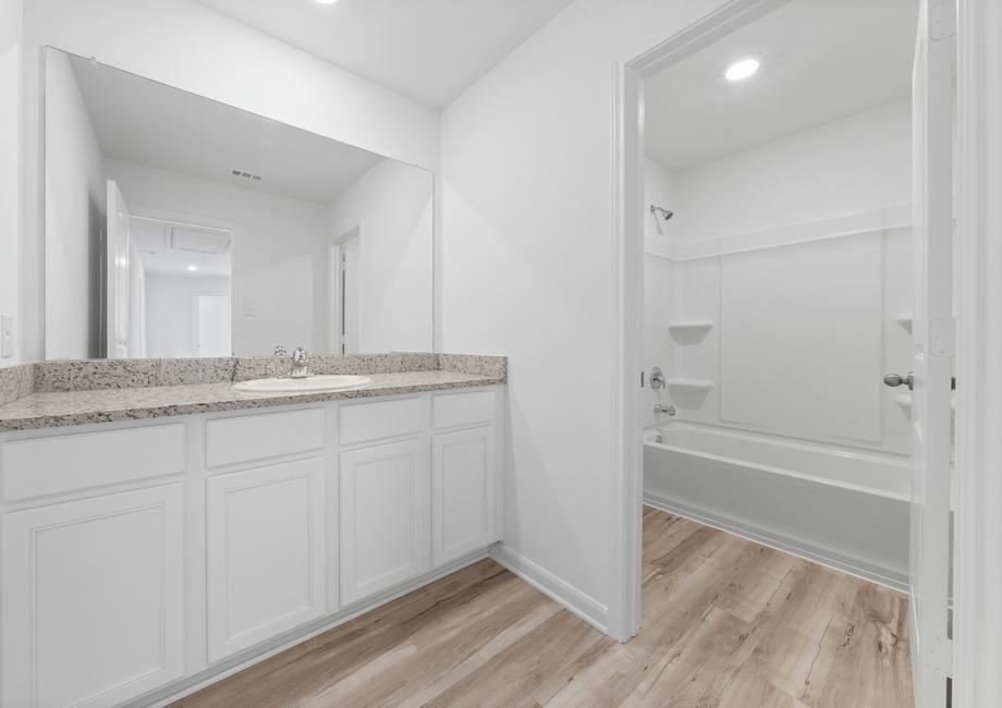 The secondary bathrooms features plenty of counterspace