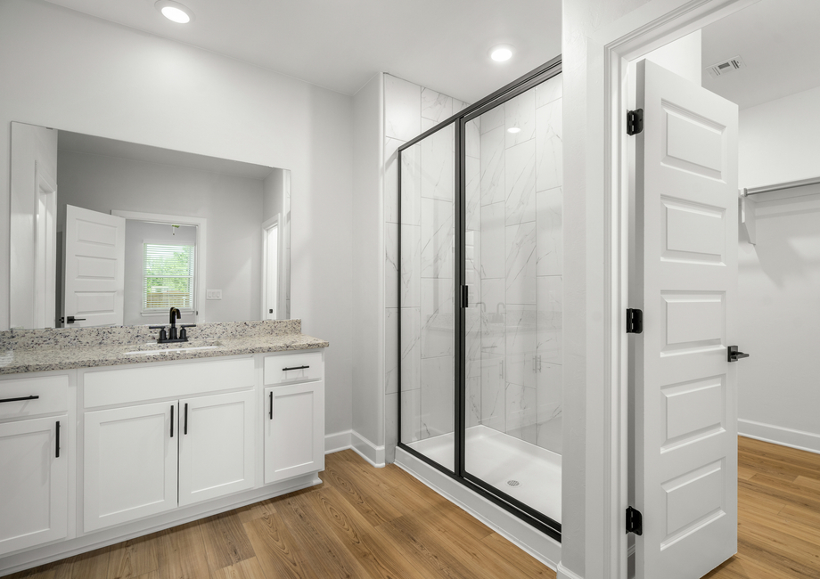 The master bathroom has a glass, walk-in shower.