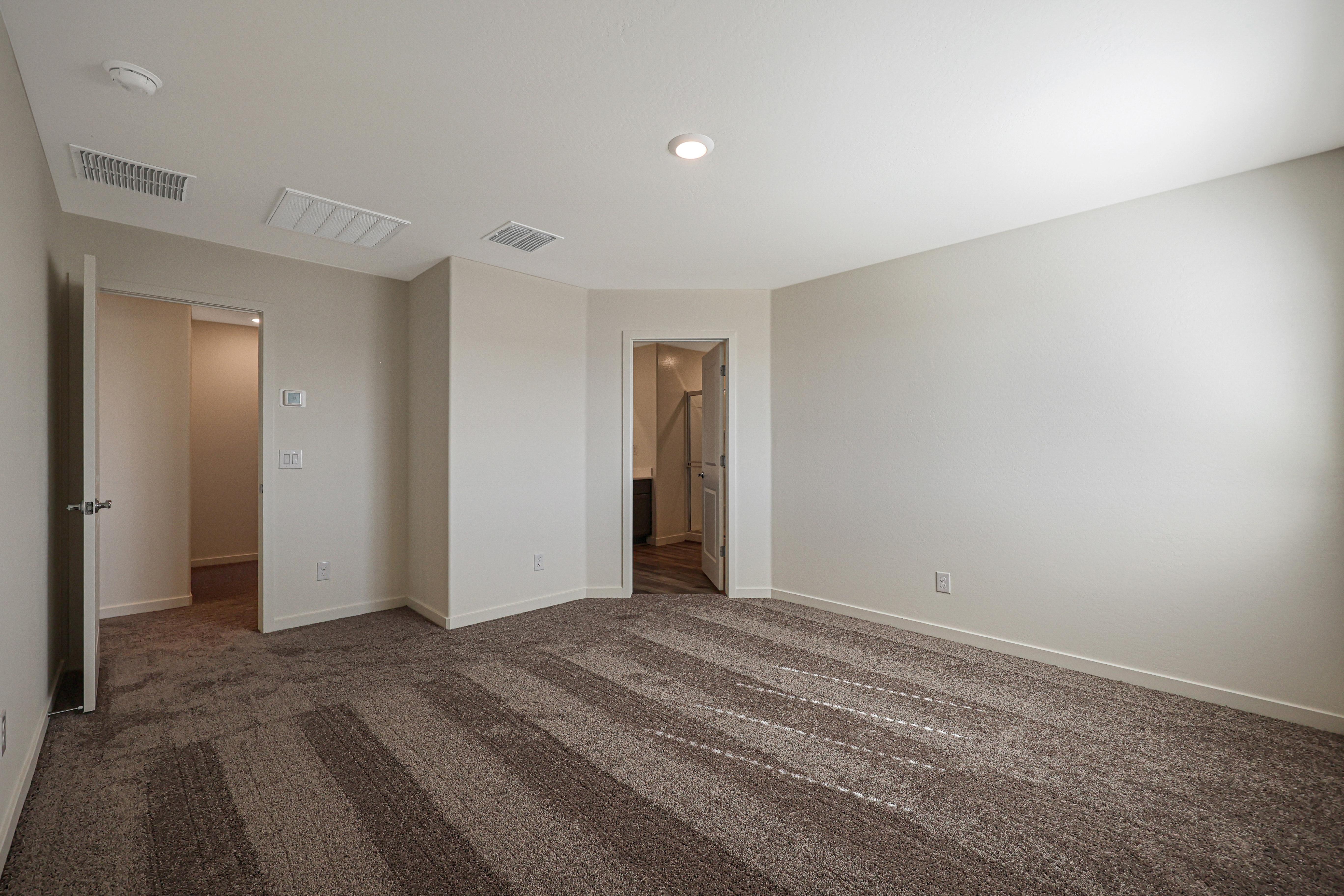 Windows let in plenty of natural light to this master bedroom.