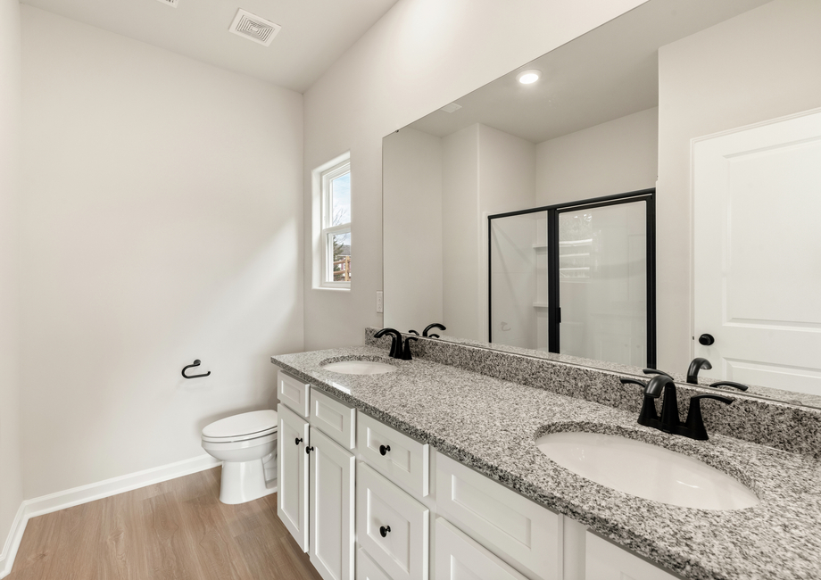 The master bathroom has dual vanities