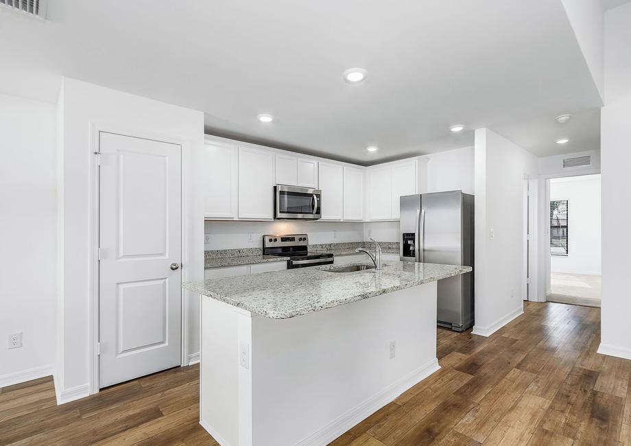 The kitchen is chef-ready with stainless steel appliances