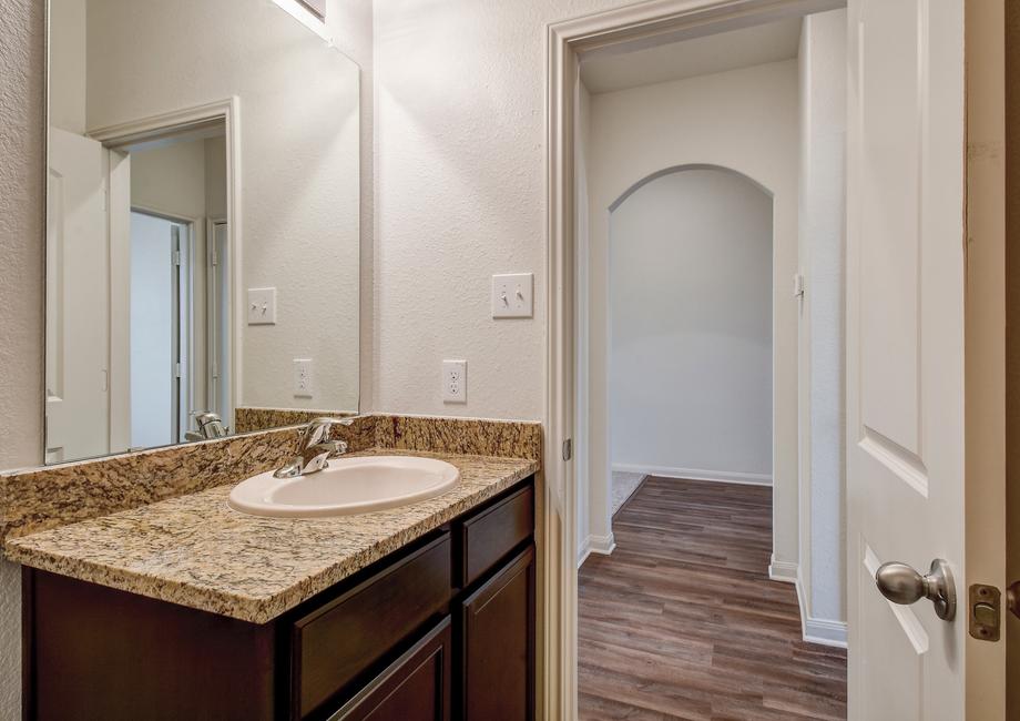 Secondary bathroom with a single-sink vanity and granite countertops.