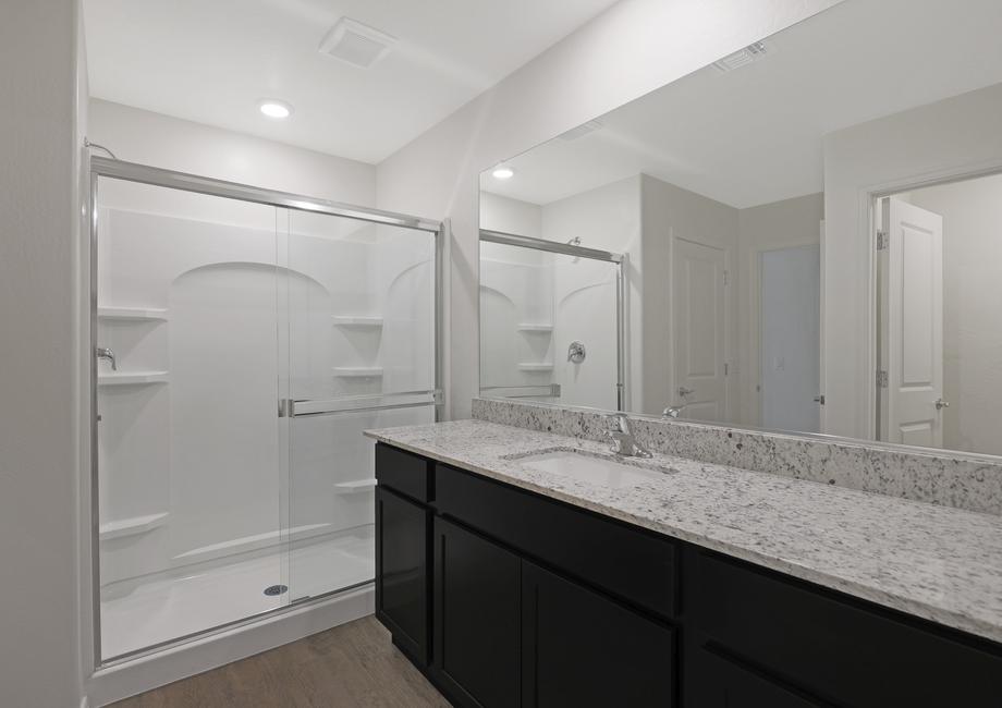 Master bathroom with granite countertops and a walk-in shower.