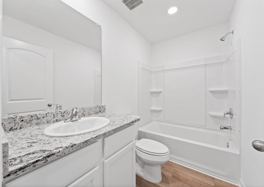 Secondary bathroom with a single-sink vanity and dual shower and tub.