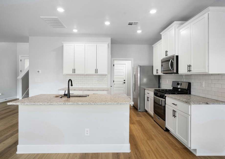 The beautiful kitchen has goregeous white wood cabinetry.